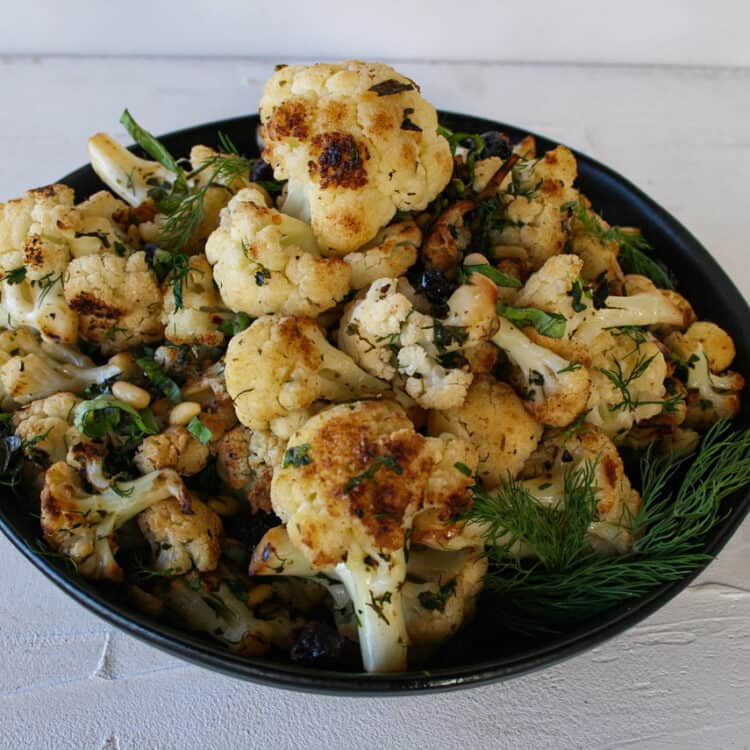 Mediterranean cauliflower in a bowl garnished with dill