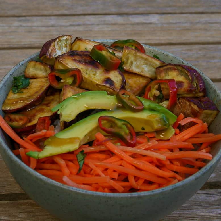 Miso Caramel Glazed Sweet Potatoes in a bowl with rice, carrots, cucumbers, and chilies