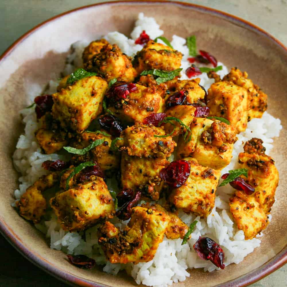 turmeric and pepper spiced tofu over rice photographed in a bowl