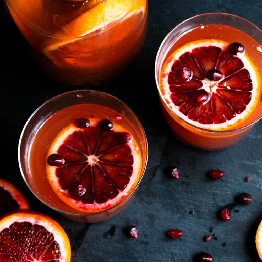 Overhead photograph of blood orange sangria with pomegranates