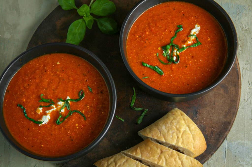 Roasted Red Pepper Soup with Whipped Feta. Served with soft French bread, and garnished with basil and extra whipped feta.