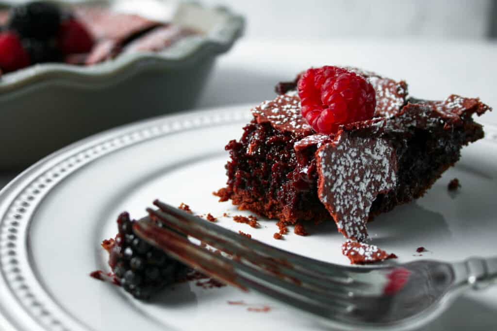 Piece of Molten Red Velvet Crackle Pie  with a raspberry on top