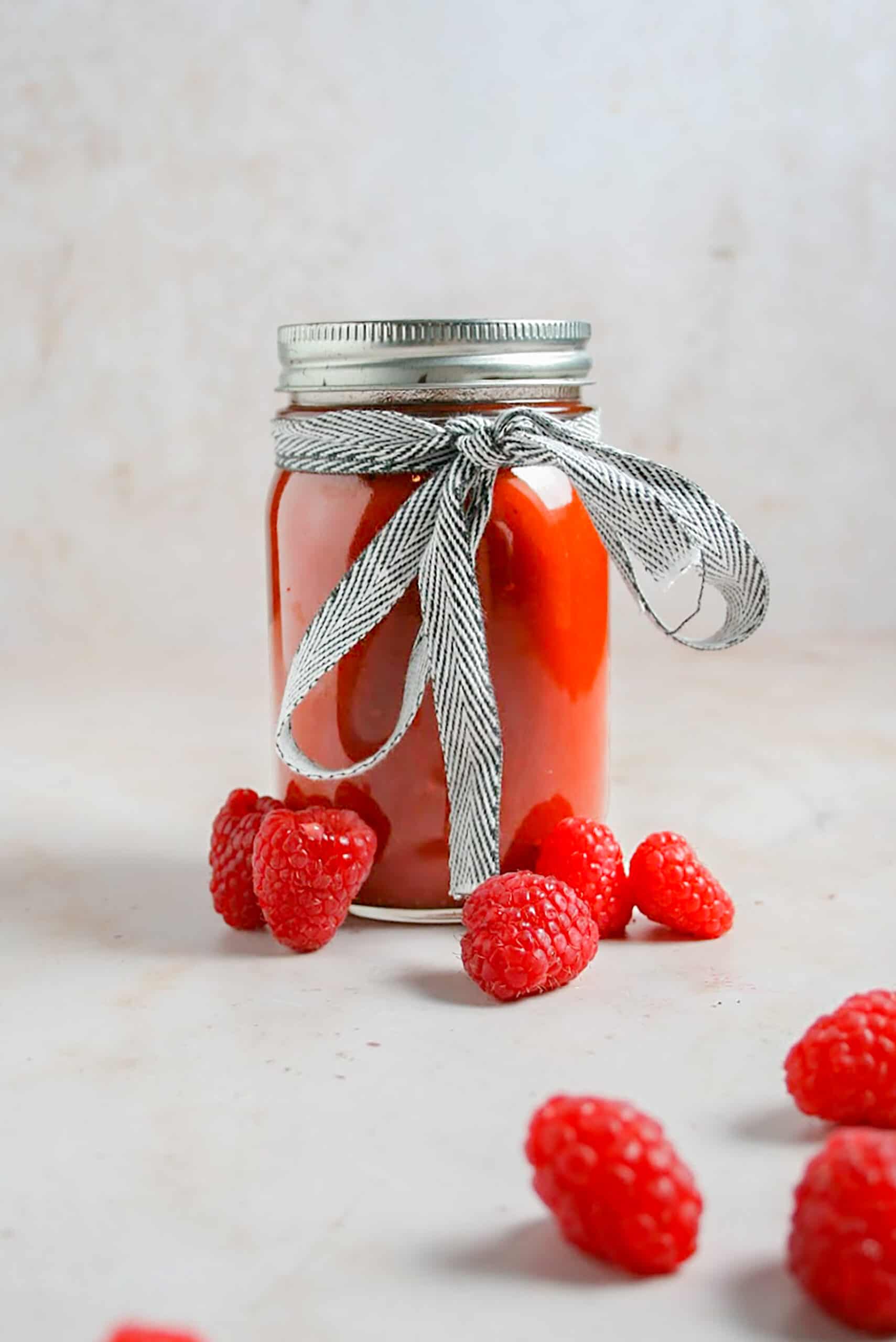 Process shot photo of Chipotle Raspberry BBQ Sauce in mason jar container storage ready for gift