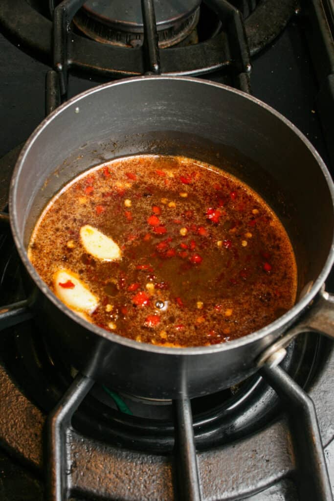 Spiced honey. Honey being infused with Calabrian chilies and garlic cloves.