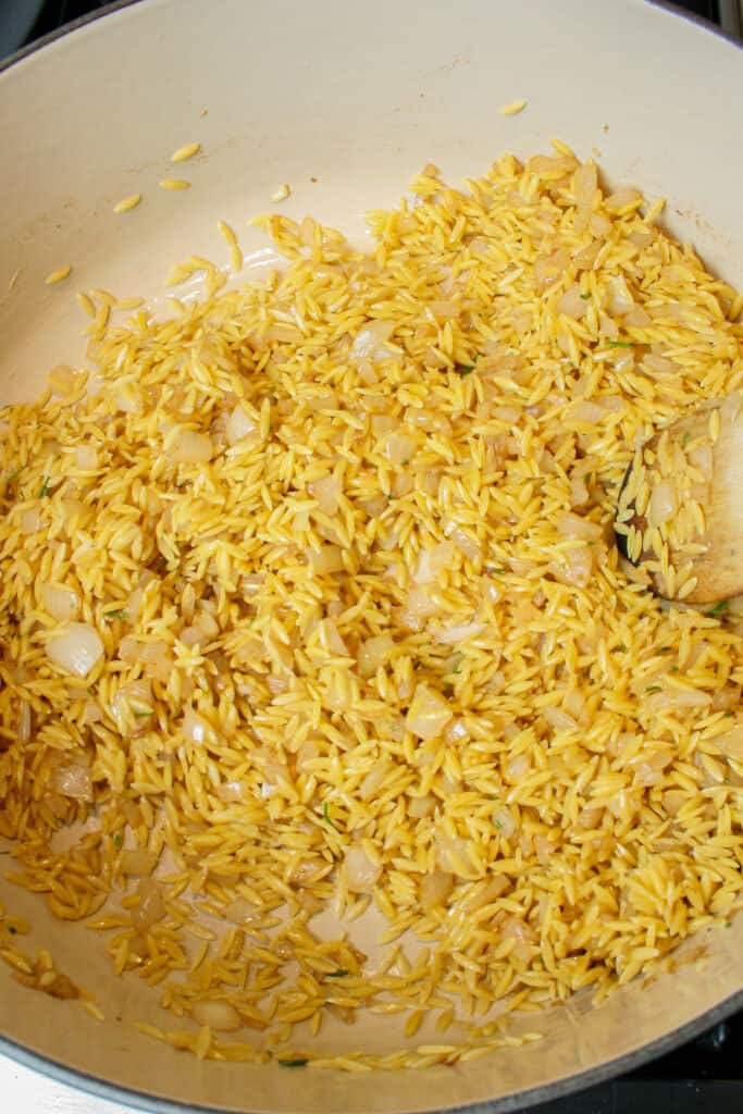 photograph of orzo being toasted for creamy rosemary orzo with shrimp dish