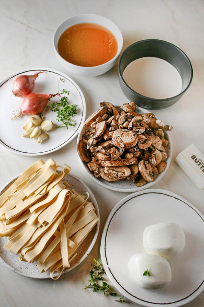 ingredient photograph of Creamy Mushroom Pasta with Burrata. Showing mushrooms, heavy cream, beef broth, shallot, garlic, parrpardelle, and burrata