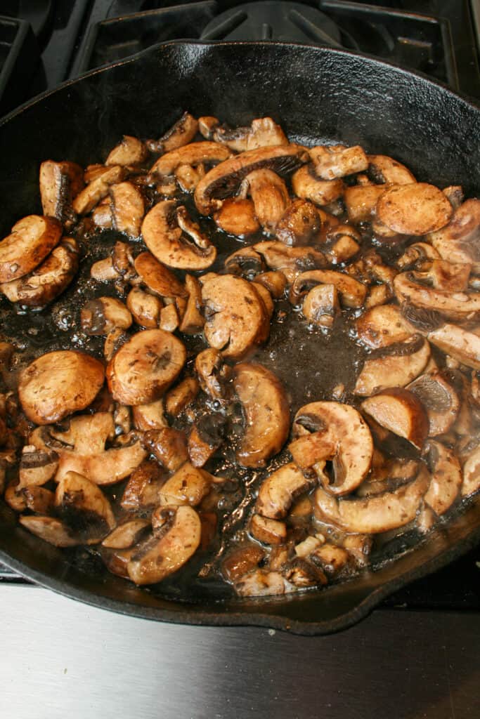 Process photograph of Creamy Mushroom Pasta with Burrata. Mushrooms cooking in brown butter