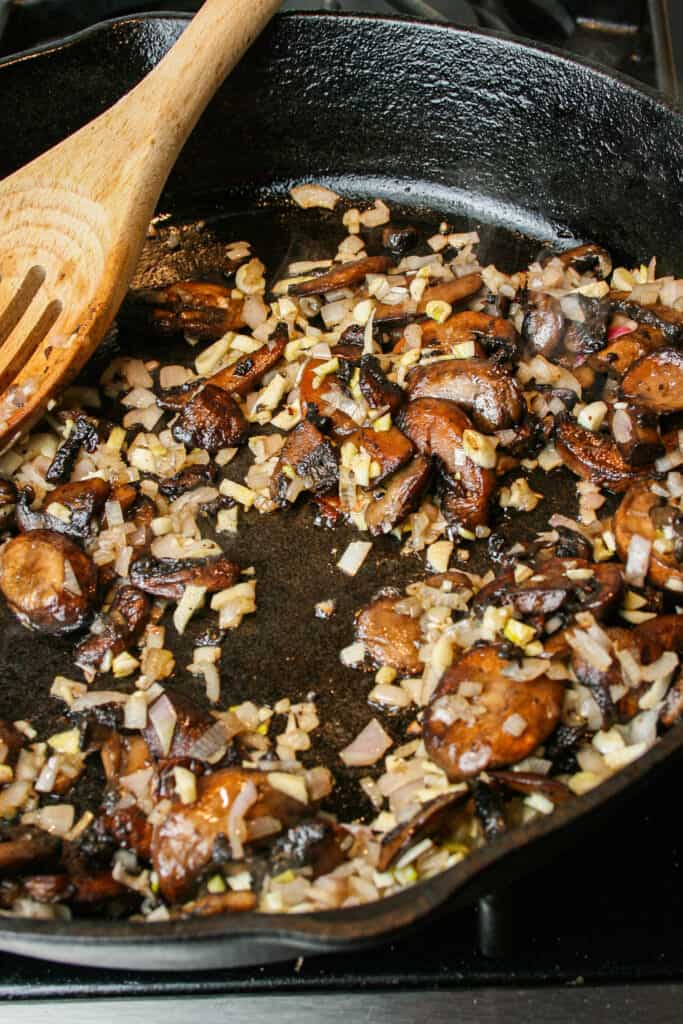 Process photograph of Creamy Mushroom Pasta with Burrata. mushrooms, shallots, garlic cooking in brown butter