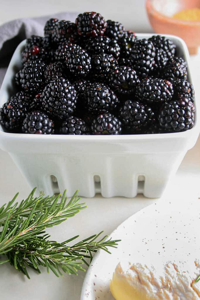 Close up photo of blackberries in a ceramic strainer