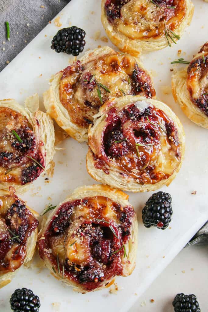 Photo of Photo of Blackberry Brie Pinwheel on a marble serving board