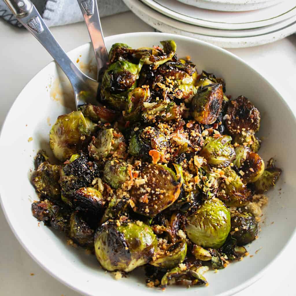 Red Wine Pan Fried Brussels sprouts photographed in a white shallow bowl