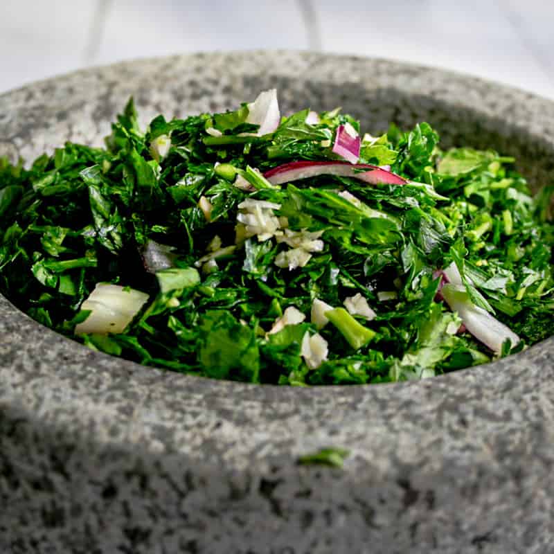 ingredients for chimichurri in a mortar and pestle