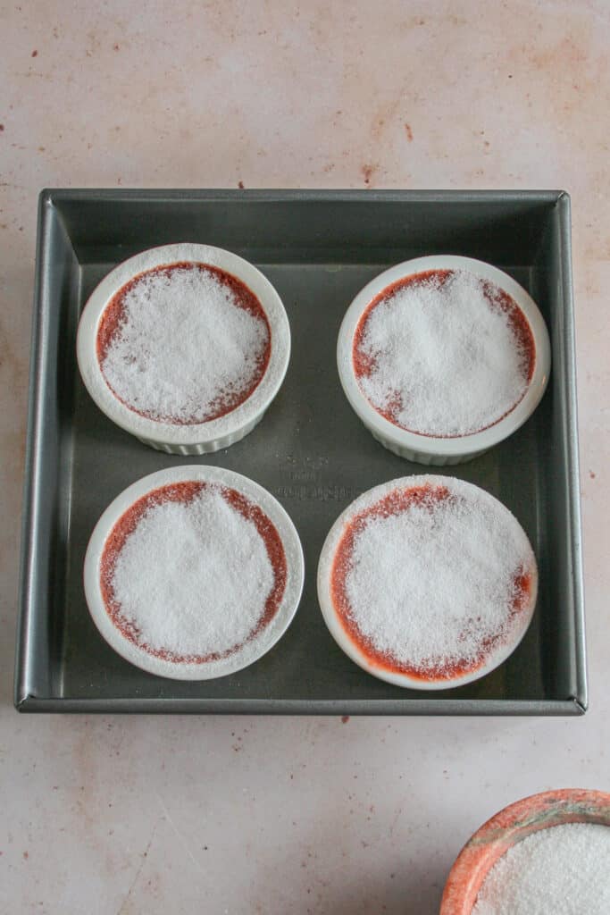 Baked red velvet creme brulee with sugar on top ready to be broiled or torched