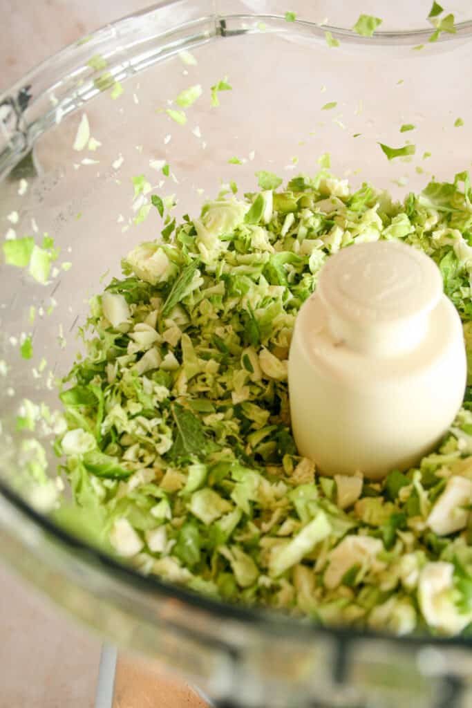 shaved brussels sprouts in a food processor