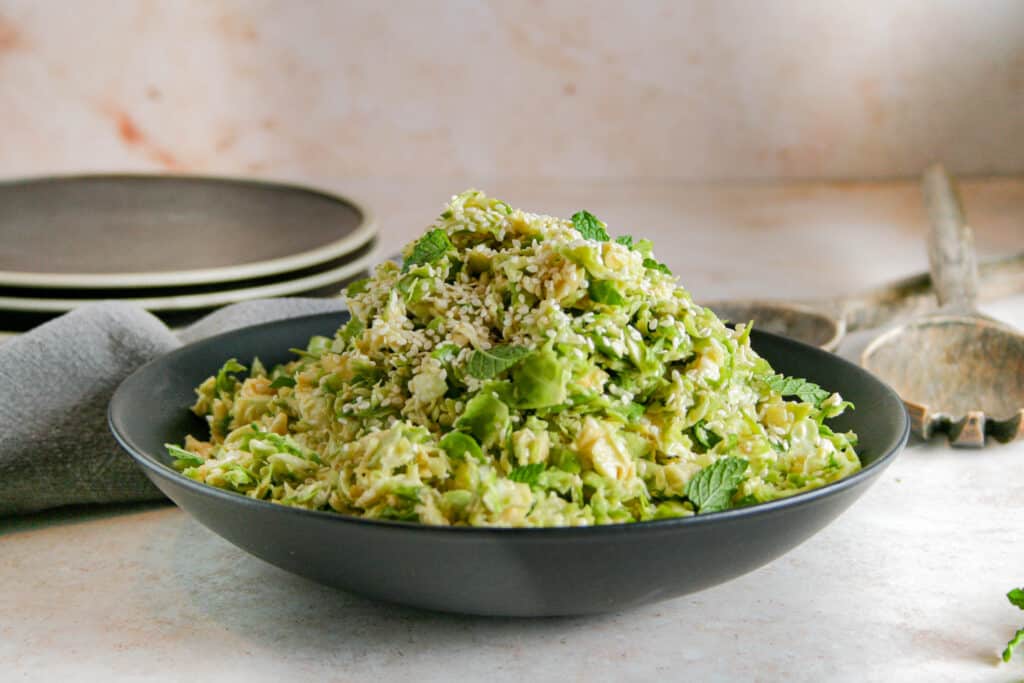 Miso brussels sprout salad in a black bowl