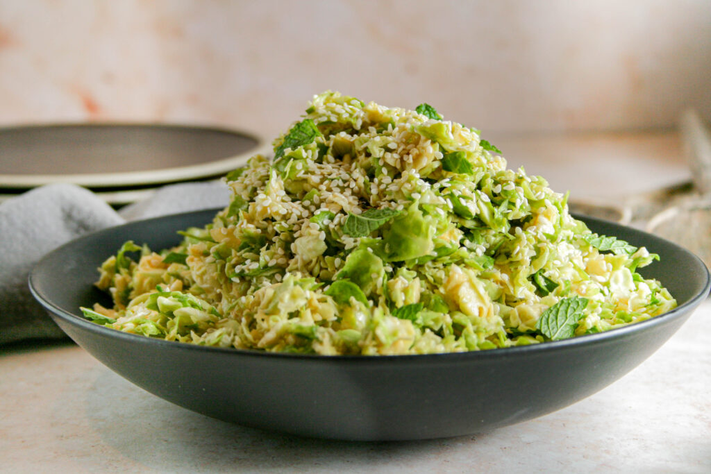 Miso brussels sprout salad in a black bowl