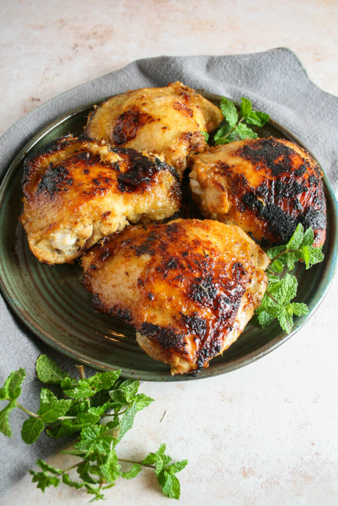 Hero shot of lemongrass chicken thighs garnished with mint