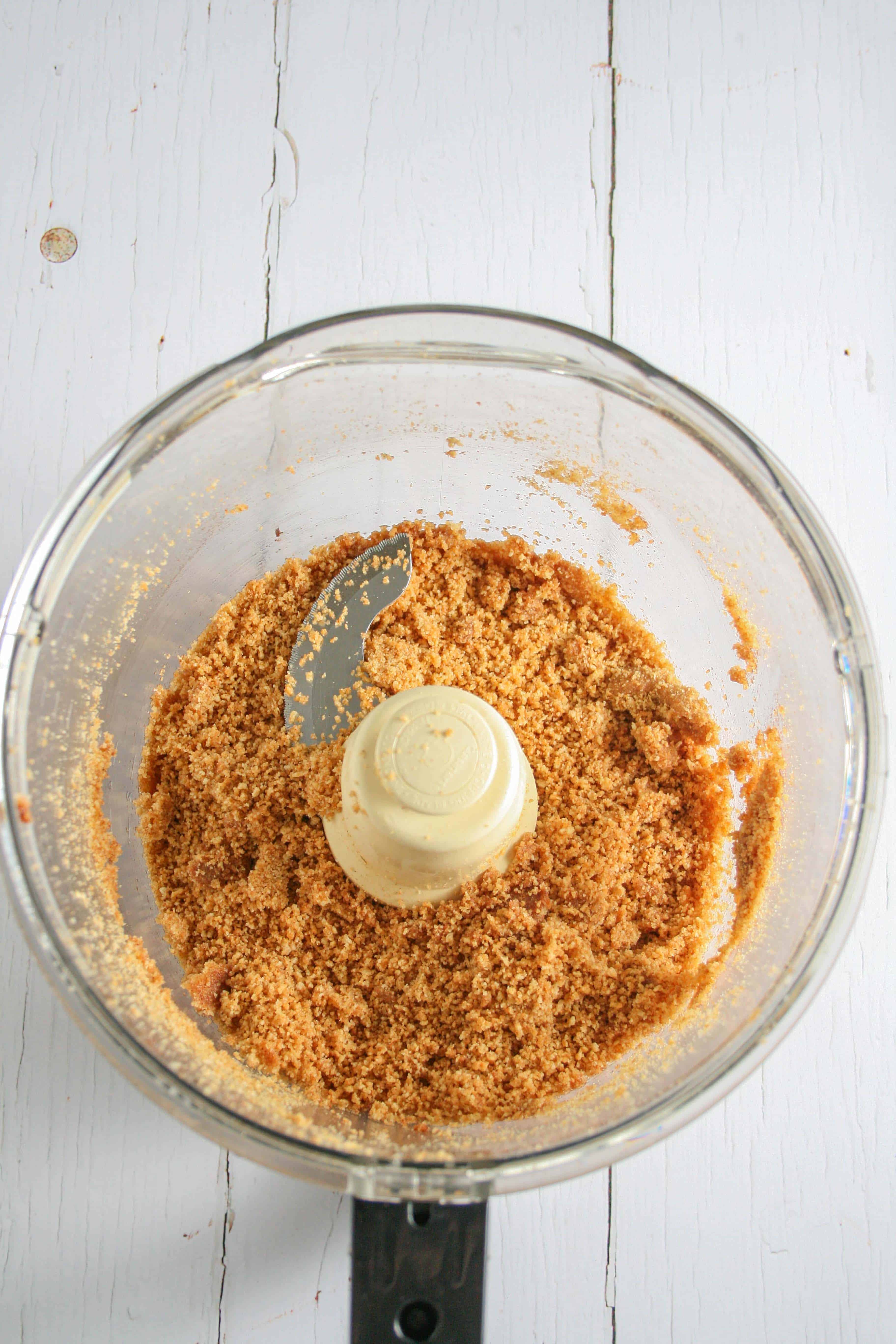 Photograph of graham crackers being ground in a food processor to make a crust