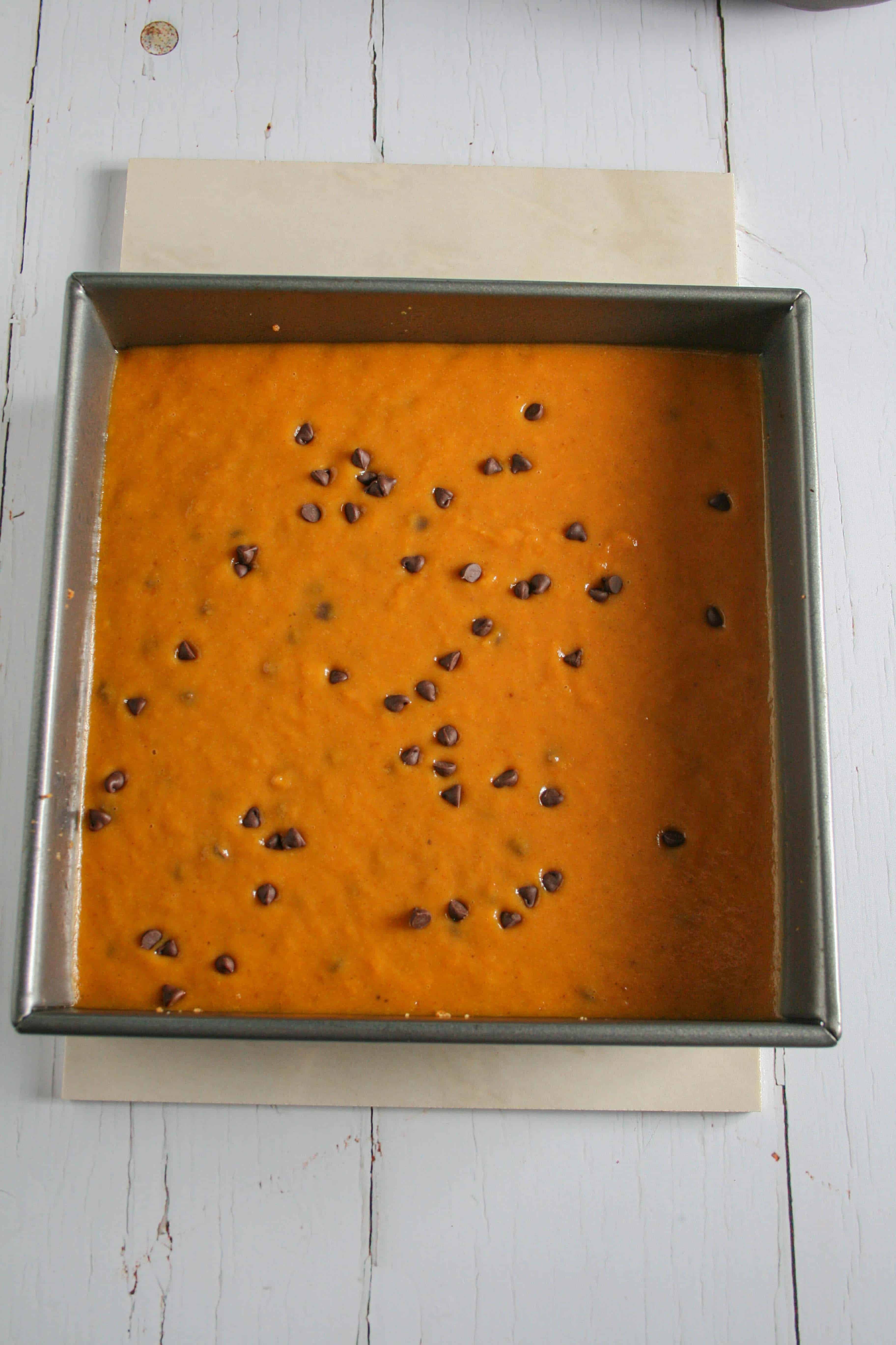 Photograph of pumpkin stores bars in a baking dish ready to bake
