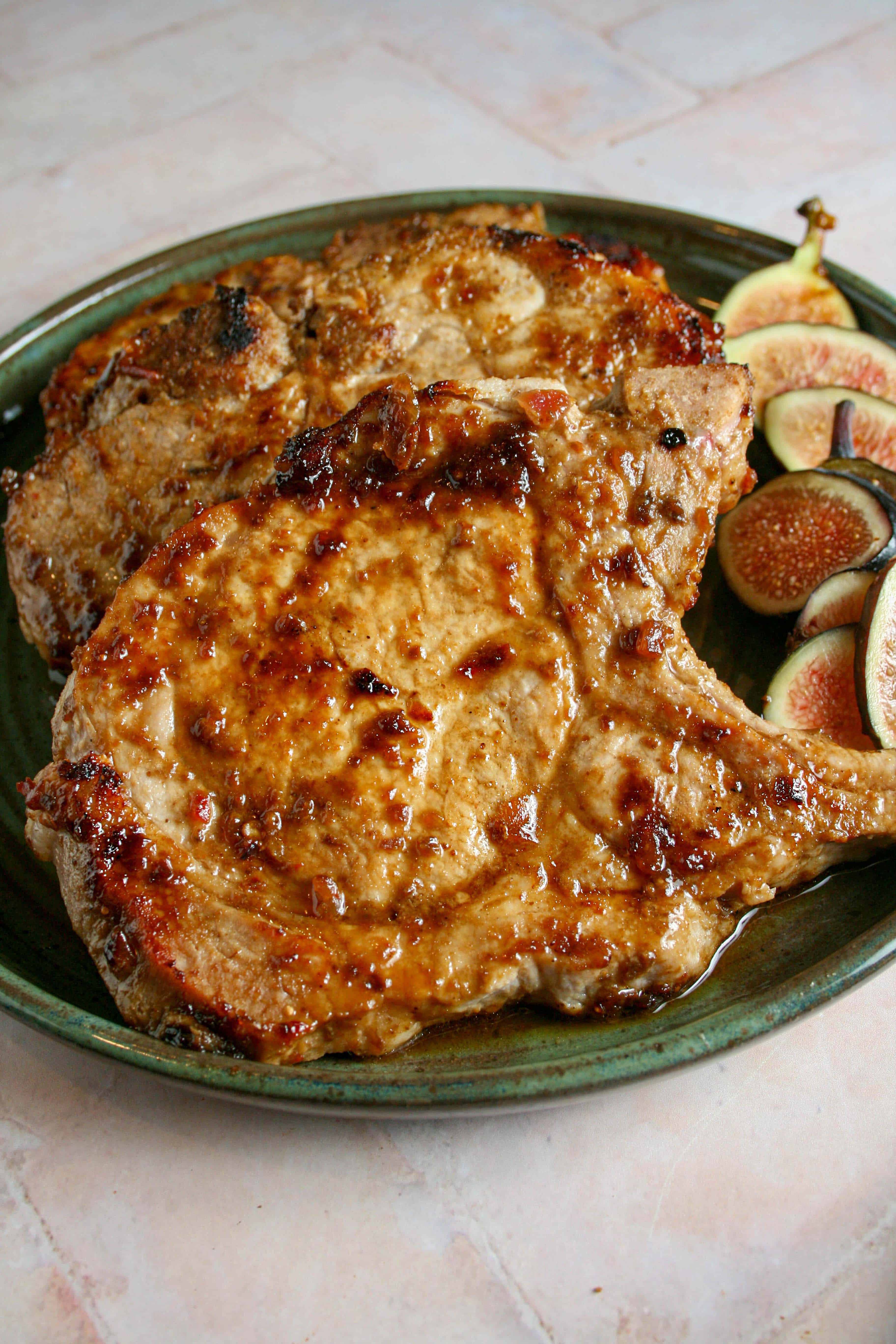 Close up photograph of pork chops with spicy fig sauce