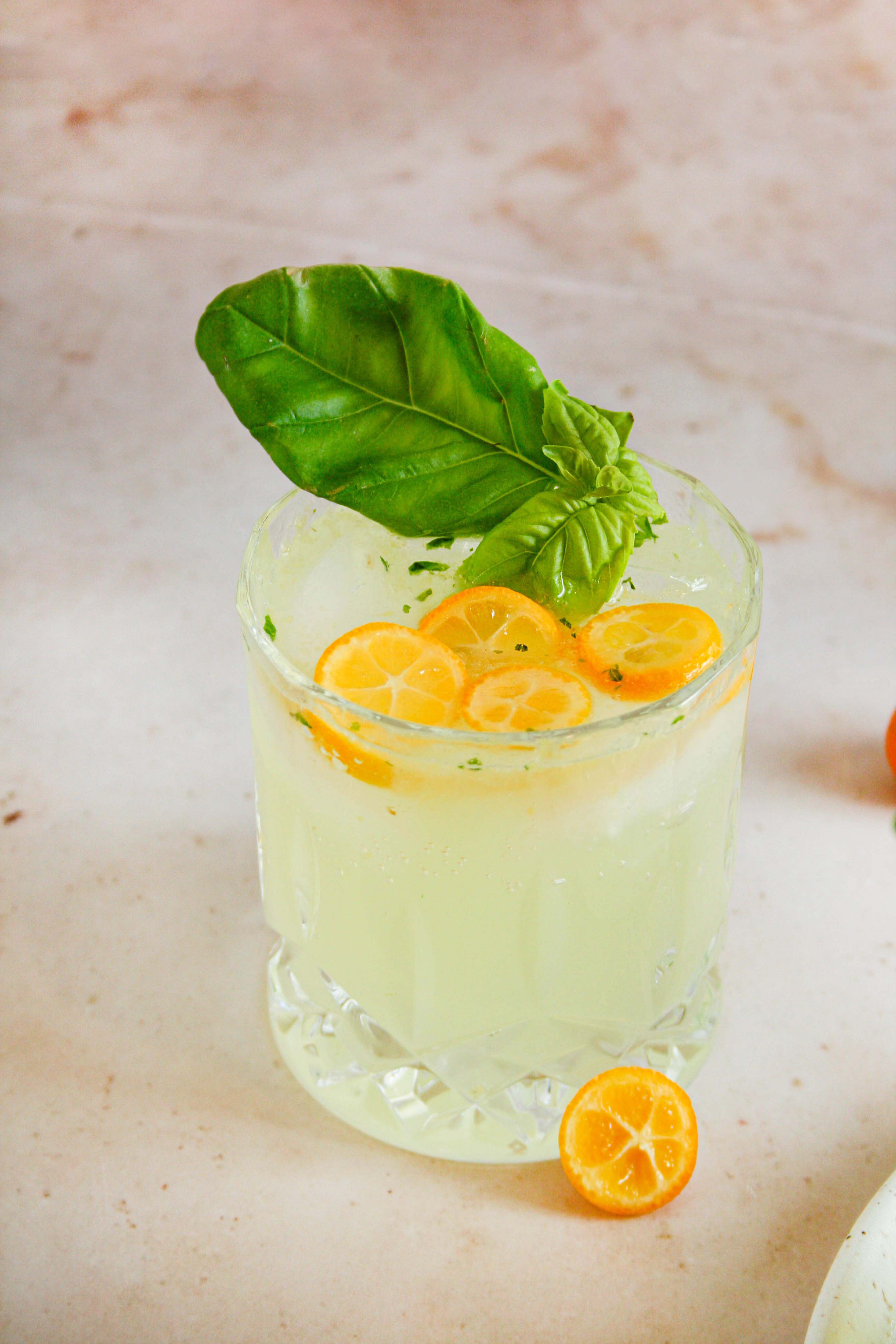 single glass of a kumquat cocktail